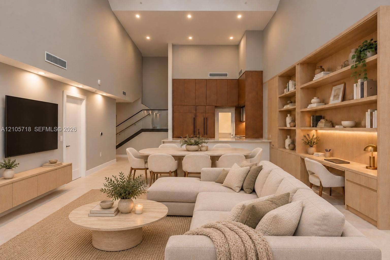 2200 Brickell Avenue, #GV16, Miami, FL 33129 High-ceiling living space featuring extensive floor-to-ceiling wood built-in shelving and desk area, recessed lighting, neutral-toned large-format tile flooring, and a sleek staircase with glass railing