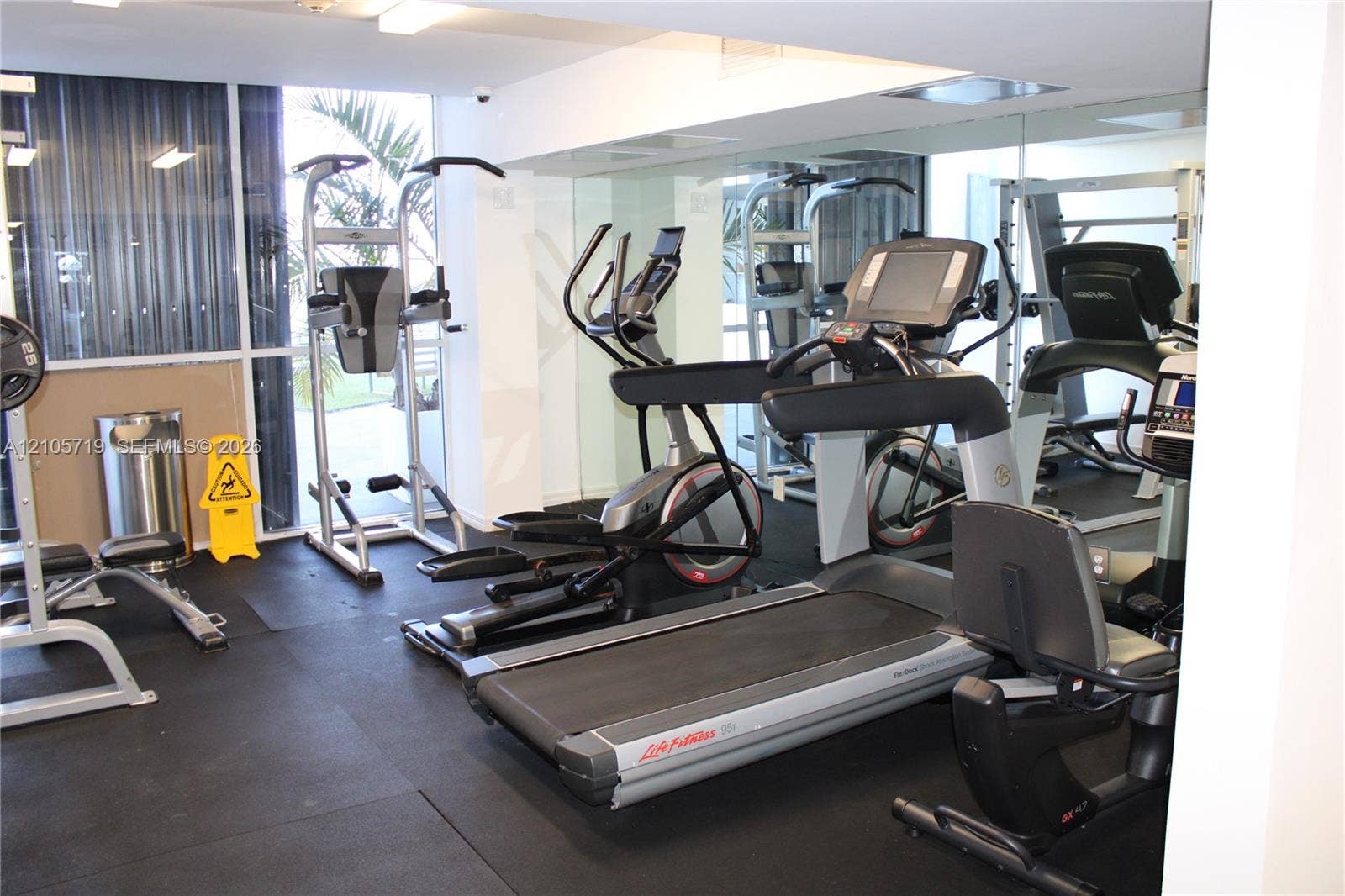 1 Glen Royal Parkway, #1510, Miami, FL 33125 Fitness center featuring rubber flooring, floor-to-ceiling mirrored walls, and floor-to-ceiling windows