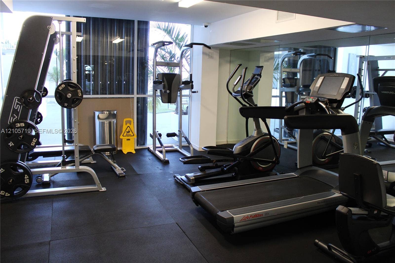 1 Glen Royal Parkway, #1510, Miami, FL 33125 Fitness center featuring floor-to-ceiling windows, mirrored walls, and rubberized flooring