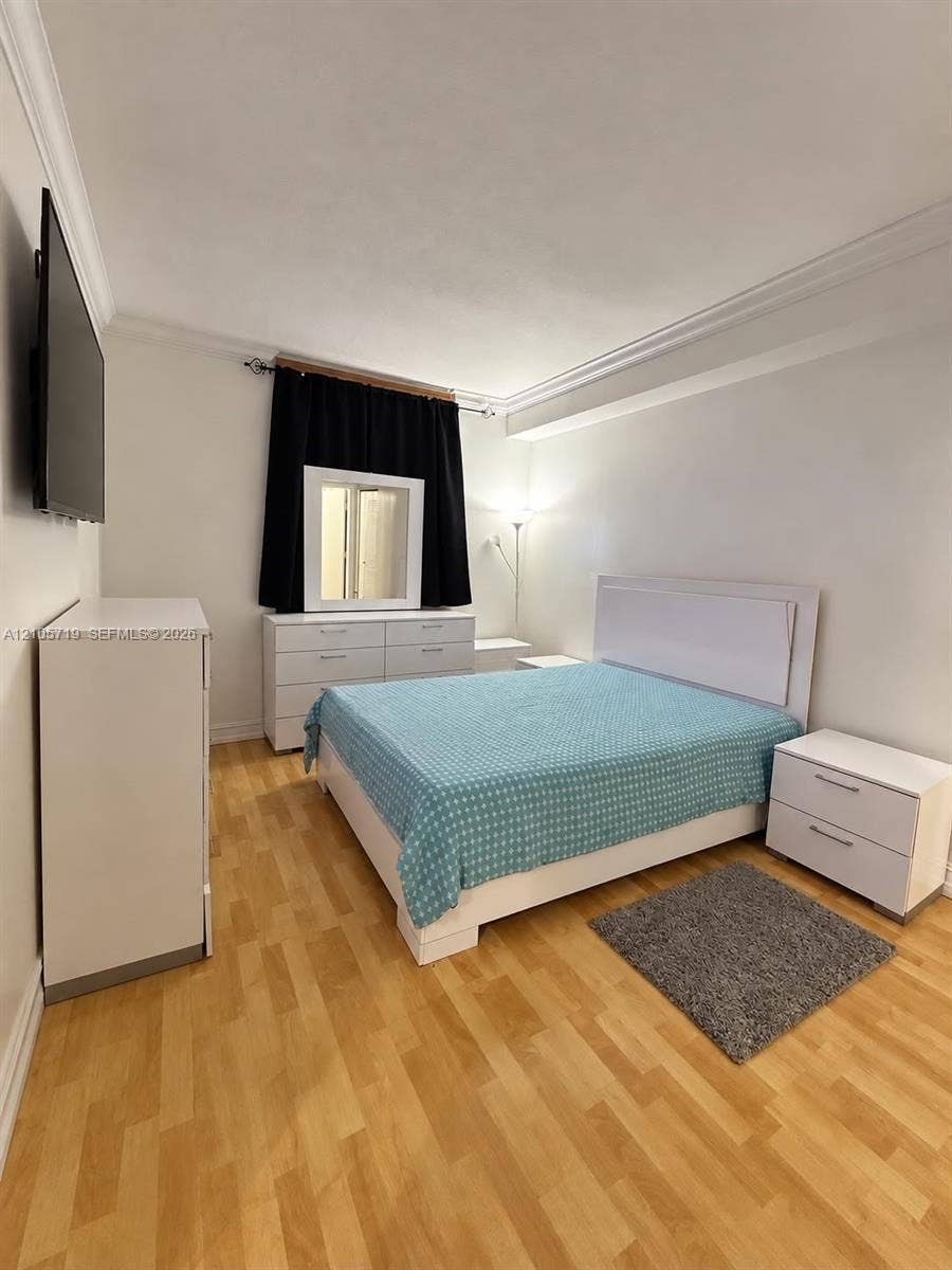 1 Glen Royal Parkway, #1510, Miami, FL 33125 Wood-finish flooring, crown molding, and neutral wall tones