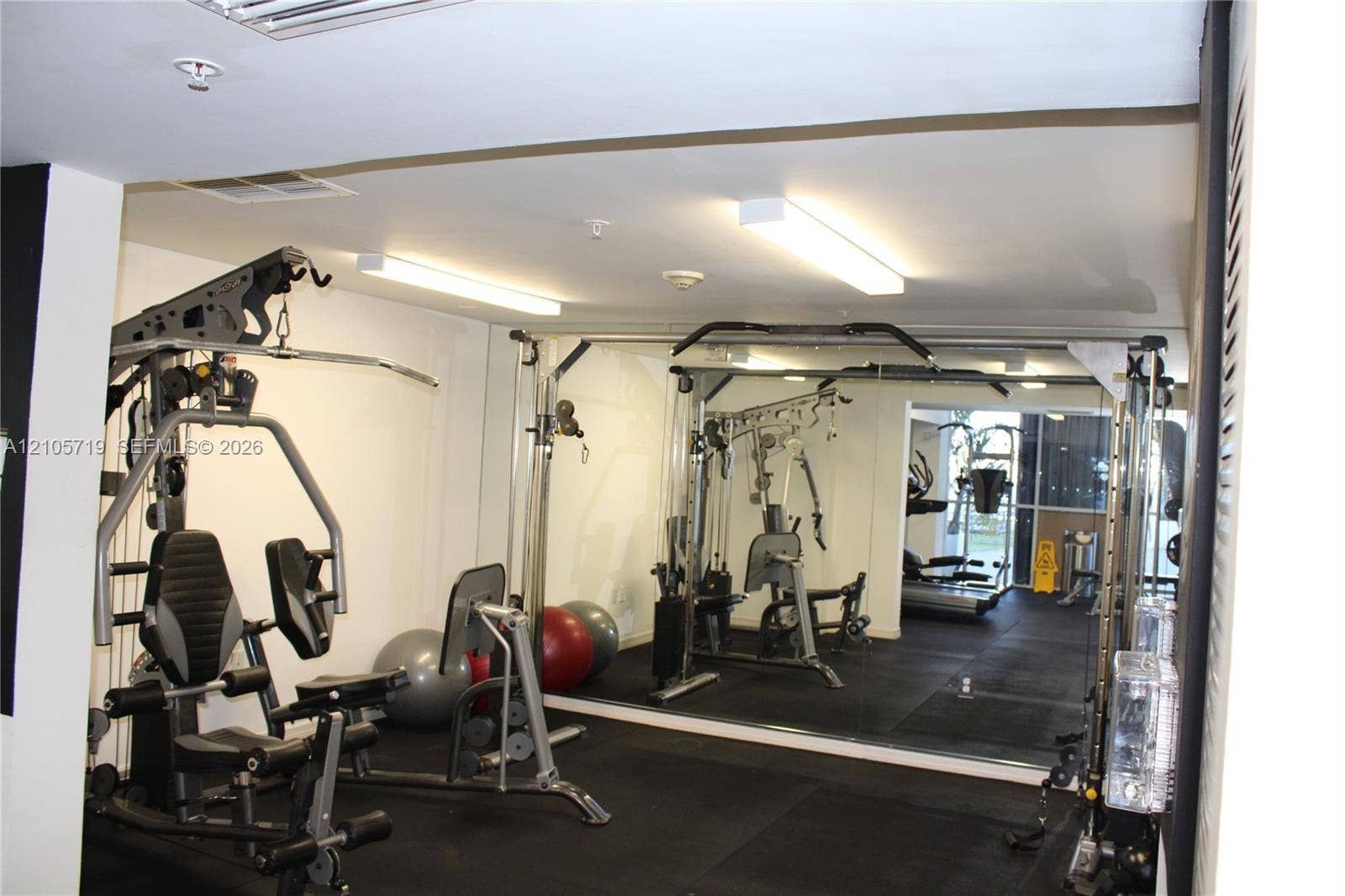 1 Glen Royal Parkway, #1510, Miami, FL 33125 Dedicated fitness area featuring wall-to-wall mirrors, recessed linear lighting, and resilient rubberized flooring