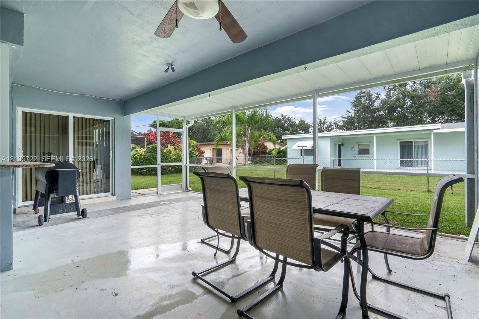 8953 SW 53rd Street, Cooper City, FL 33328 Screened-in patio featuring a concrete floor, ceiling fan, and sliding glass door entry