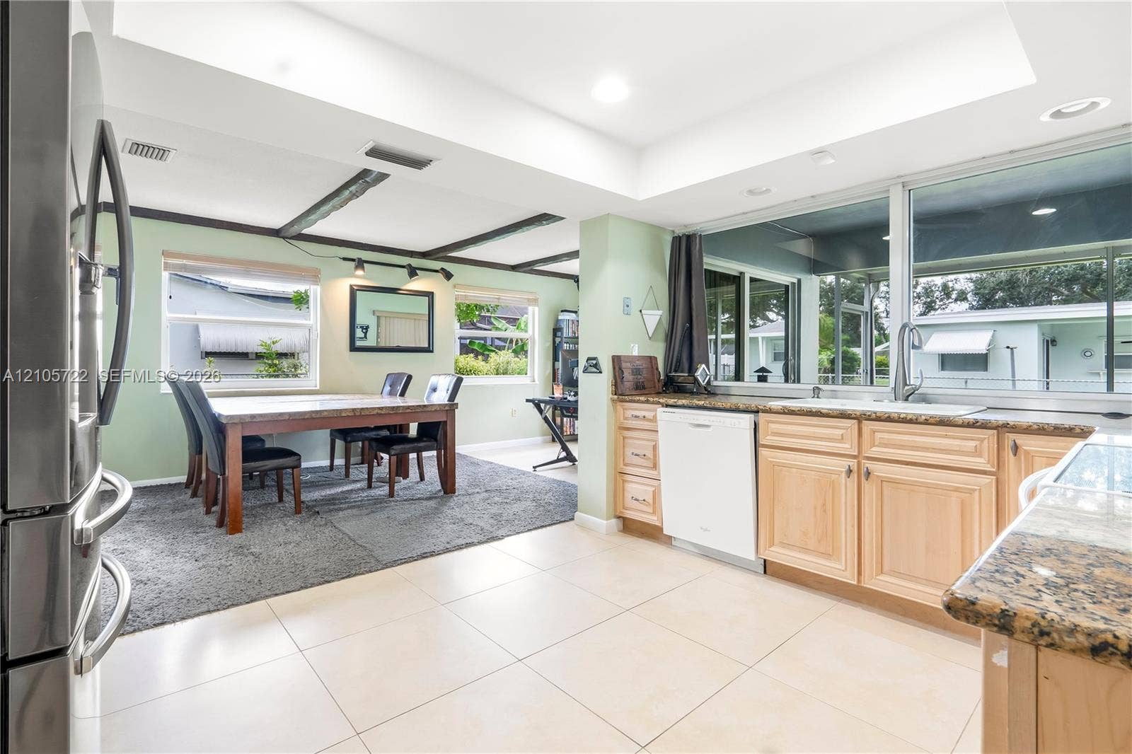 8953 SW 53rd Street, Cooper City, FL 33328 Kitchen featuring light-finish cabinetry, stone countertops, integrated dishwasher, tile flooring, and a recessed ceiling design with exposed wood beams