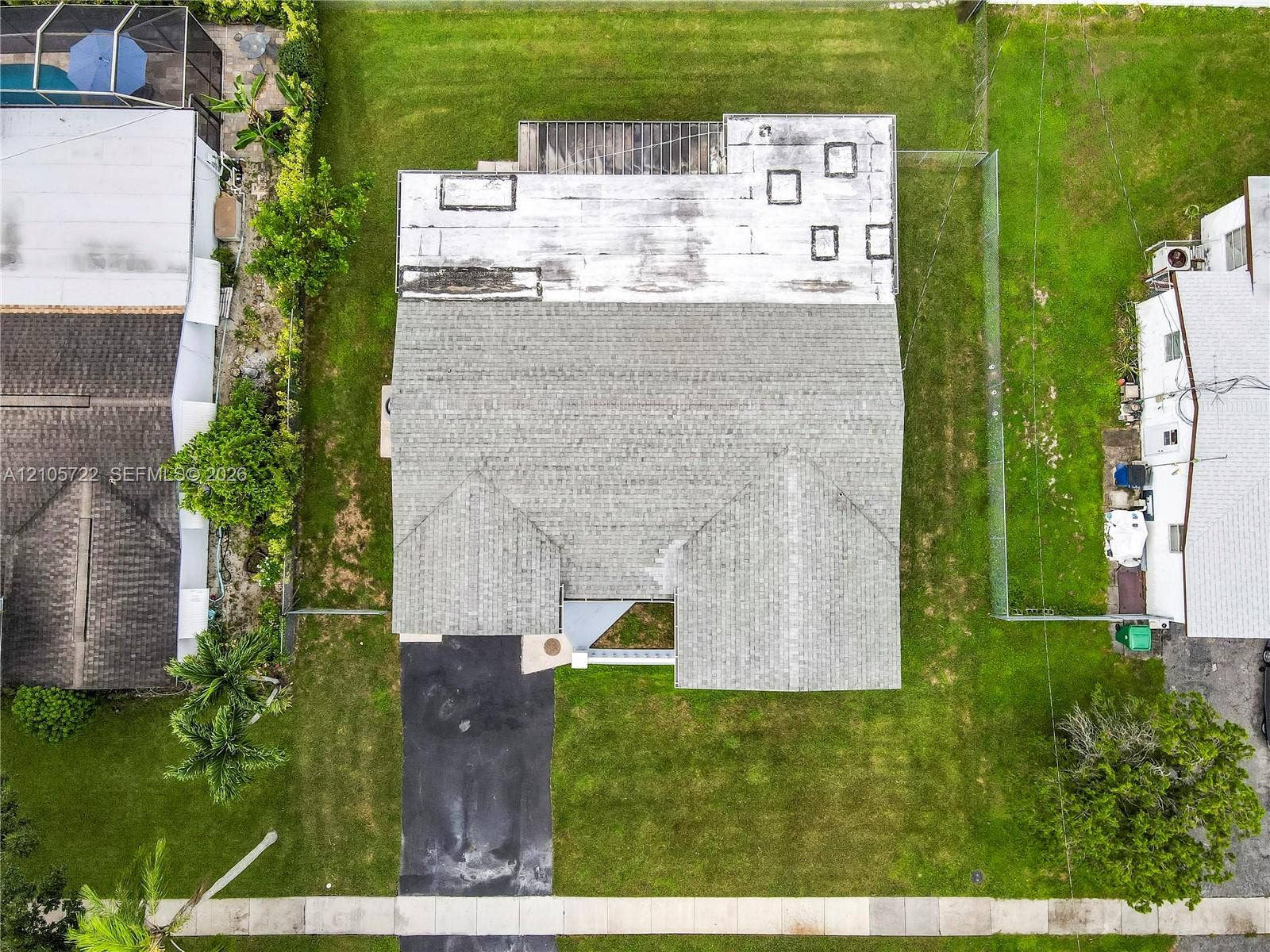 8953 SW 53rd Street, Cooper City, FL 33328 Single-story residence featuring a shingle roof, attached one-car garage, exterior shutters, and a concrete driveway on a landscaped lot
