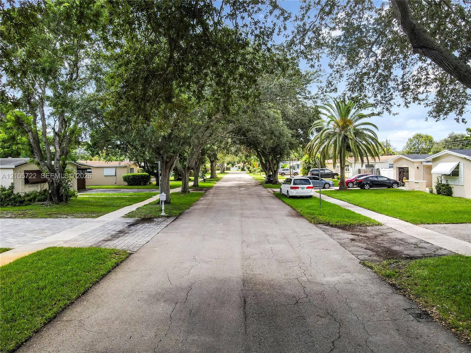8953 SW 53rd Street, Cooper City, FL 33328 Aerial view featuring an asphalt driveway, fenced-in perimeter, and a flat roof section with skylights