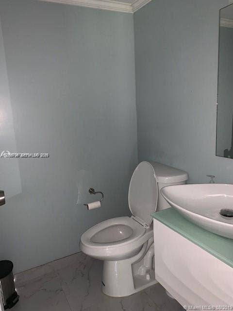 200 172nd Street, #101, Sunny Isles Beach, FL 33160 Wall-mounted vanity with a frosted glass countertop and white vessel sink, paired with a white two-piece toilet and large-format tile flooring