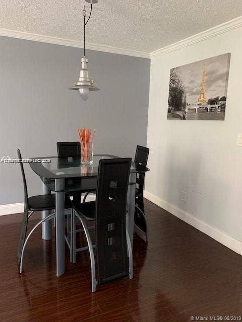 200 172nd Street, #101, Sunny Isles Beach, FL 33160 Wood-finish flooring, industrial-style pendant lighting, and neutral wall tones