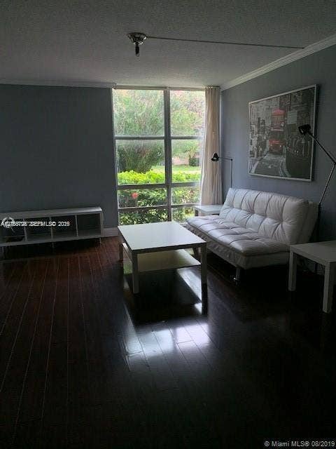 200 172nd Street, #101, Sunny Isles Beach, FL 33160 Dark wood-finish flooring, floor-to-ceiling multi-pane window, and crown molding