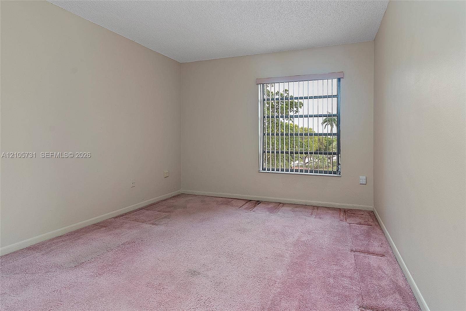 5700 SW 127th Avenue, #1404, Miami, FL 33183 Interior room featuring neutral wall paint, wall-to-wall carpeting, and a window with vertical blinds