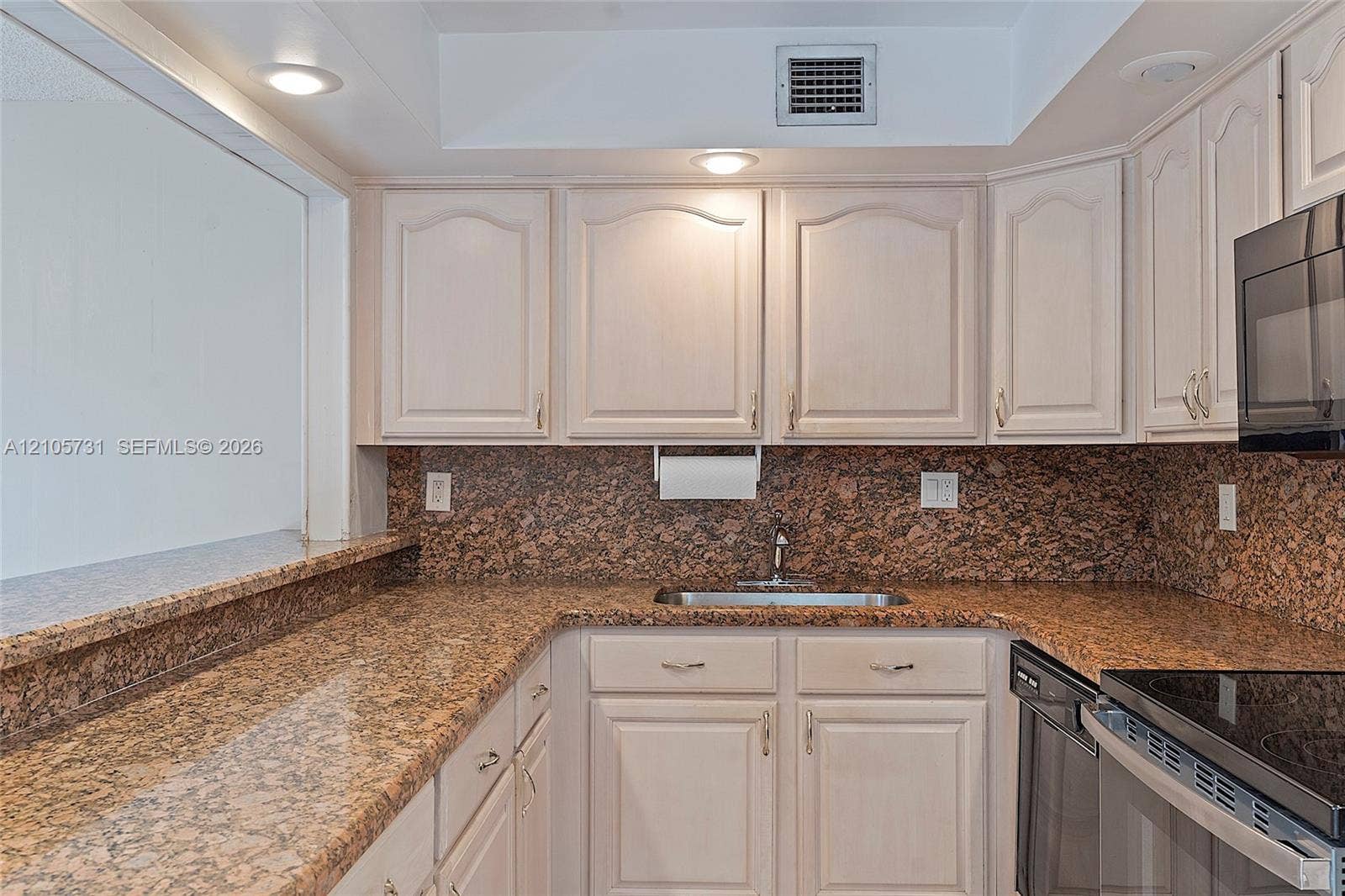 5700 SW 127th Avenue, #1404, Miami, FL 33183 Kitchen featuring stone countertops, stone tile backsplash, light-finish cabinetry, built-in black microwave, and recessed lighting