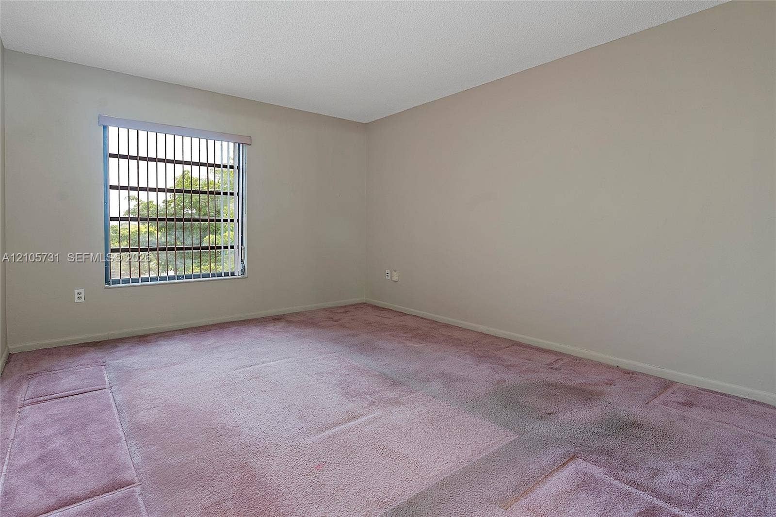 5700 SW 127th Avenue, #1404, Miami, FL 33183 Neutral wall finishes, textured ceiling, vertical window blinds, and wall-to-wall carpeting