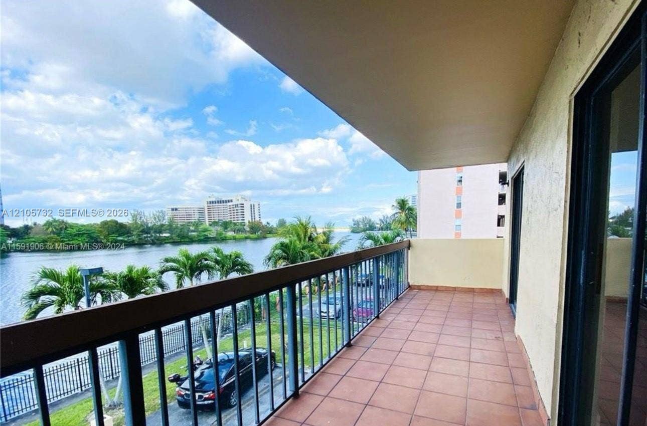 5249 NW 7th Street, #219, Miami, Miami, FL 33126 Covered balcony featuring tile flooring and metal railings, overlooking the waterfront
