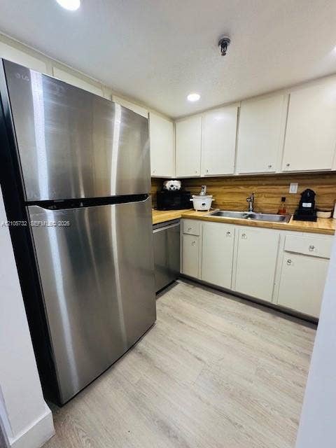 5249 NW 7th Street, #219, Miami, Miami, FL 33126 Kitchen featuring stainless steel appliances, wood-finish countertops, shaker-style cabinetry, a dual-basin stainless steel sink with a goose-neck faucet, and wood-finish flooring