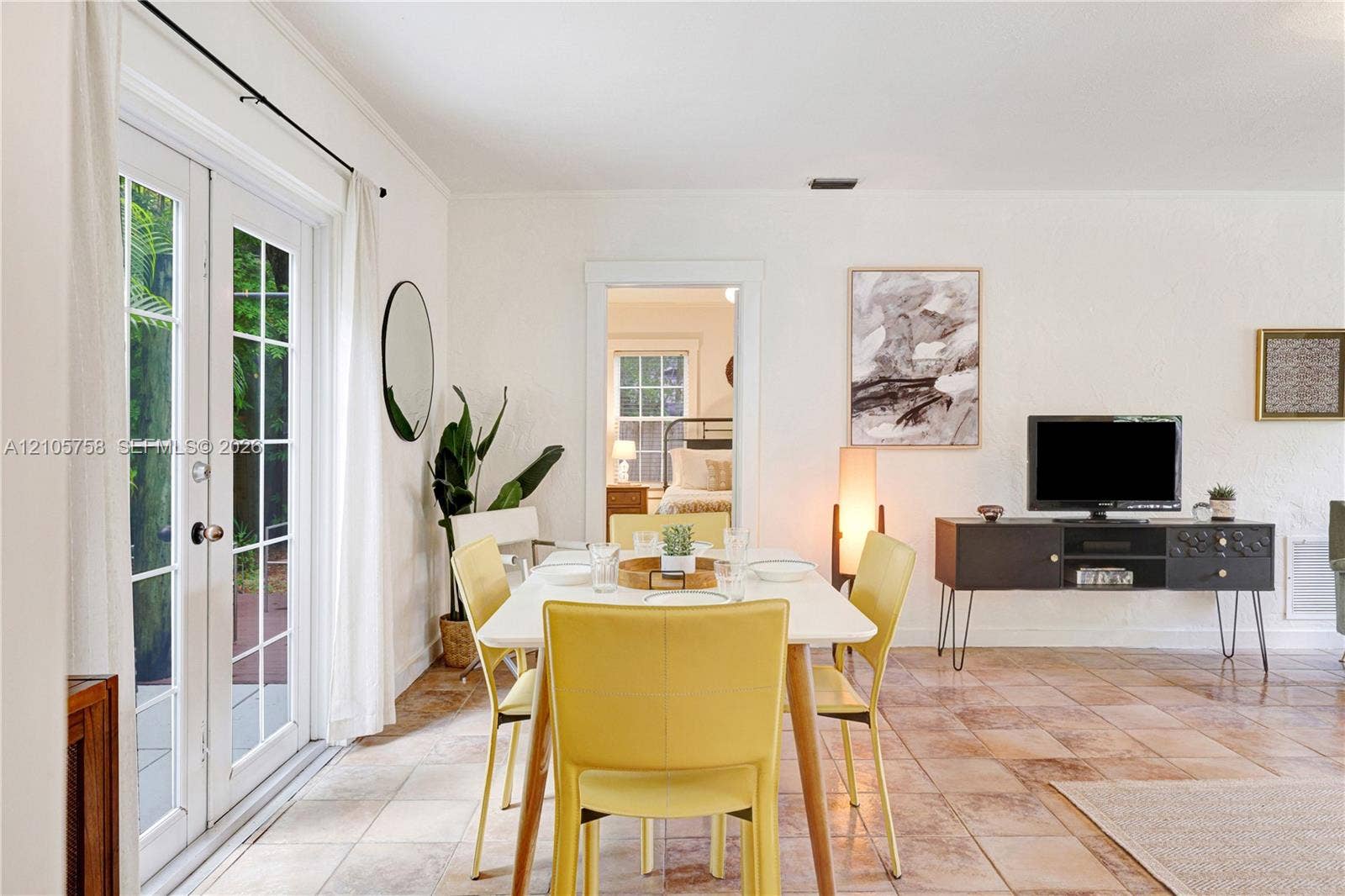 668 NE 70th Street, Miami, FL 33138 Tile flooring, glass-paned French doors, and a doorway featuring decorative molding
