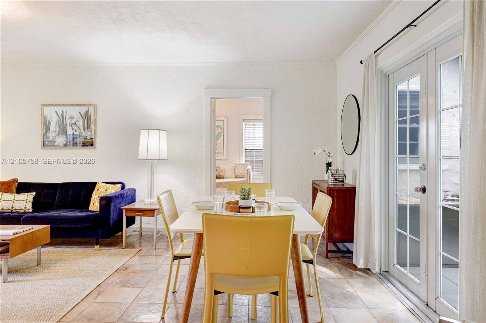 668 NE 70th Street, Miami, FL 33138 Textured wall finish, stone-tile flooring, and full-glass panel French doors