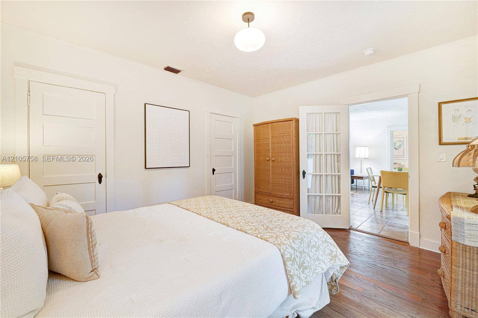 668 NE 70th Street, Miami, FL 33138 Room featuring wood-finish flooring, white five-panel interior doors, and a glass-paned French door
