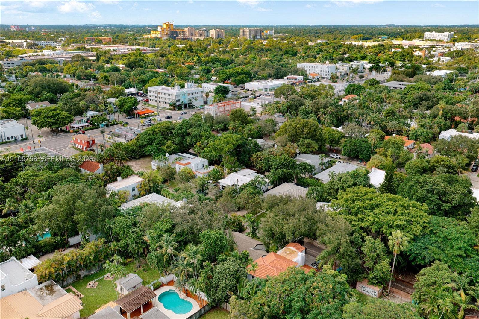 668 NE 70th Street, Miami, FL 33138 Aerial perspective featuring established tree canopy, residential hardscaping, and a swimming pool