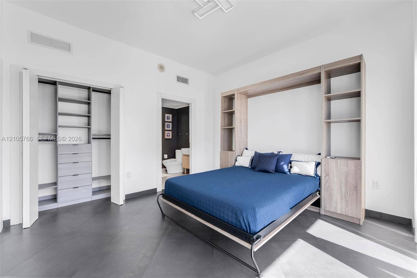 200 Biscayne Boulevard Way, #4408, Miami, FL 33131 Secondary bedroom with fitted reach-in closet, Murphy bed and its own bath.