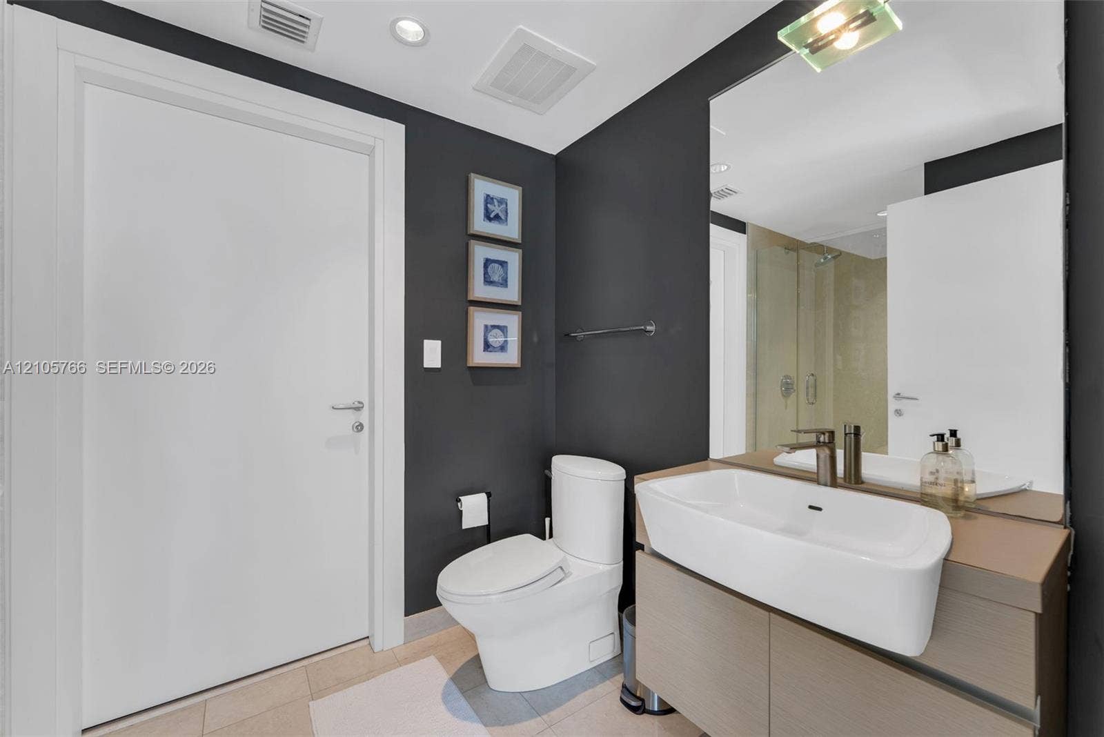 200 Biscayne Boulevard Way, #4408, Miami, FL 33131 Second bath with floating vanity and a glass-enclosed rain shower.