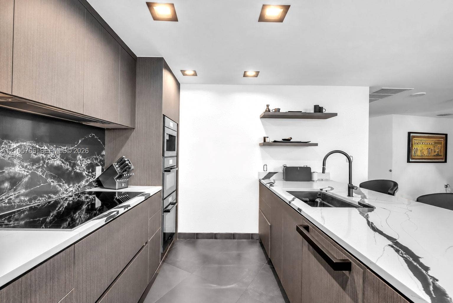 200 Biscayne Boulevard Way, #4408, Miami, FL 33131 Kitchen with flush Miele cooktop, oven column and panel-front dishwasher.