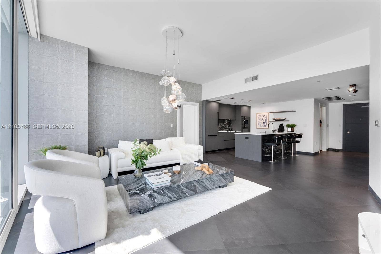 200 Biscayne Boulevard Way, #4408, Miami, FL 33131 Living room with floor-to-ceiling glass, open to the kitchen island with seating for 3.