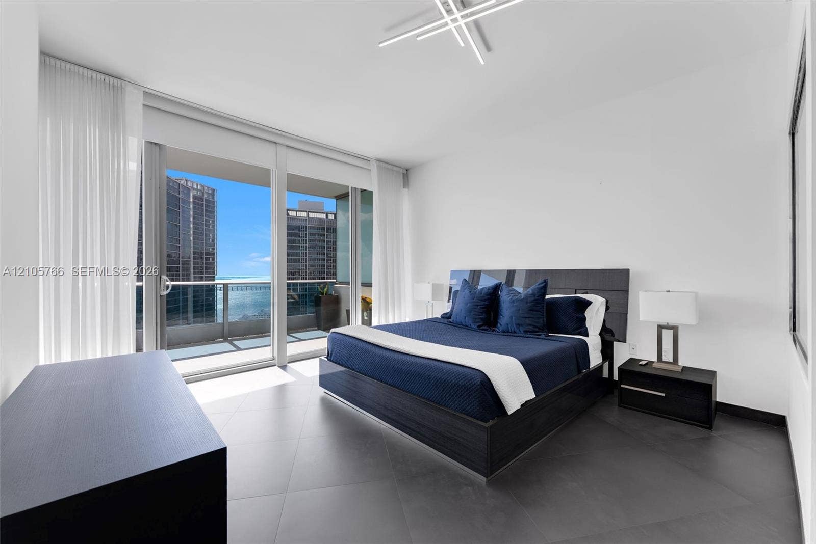 200 Biscayne Boulevard Way, #4408, Miami, FL 33131 Primary bedroom with sliding doors to the private terrace and bay views.