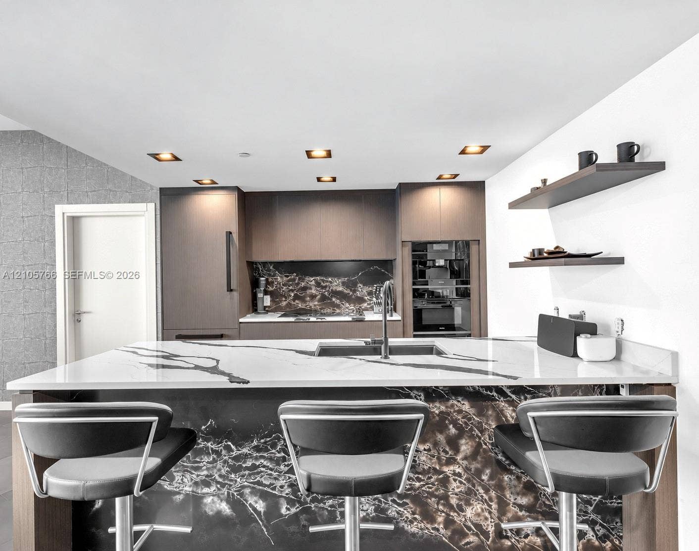 200 Biscayne Boulevard Way, #4408, Miami, FL 33131 Kitchen island with sink and seating for 3, facing the Miele oven and coffee column.