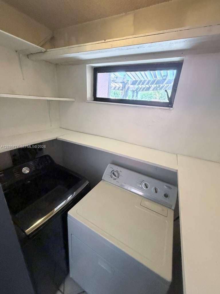 10343 Greenhouse Road, Pembroke Pines, FL 33026 Utility area featuring built-in white shelving and a horizontal hopper window