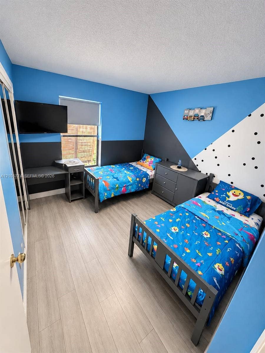 10343 Greenhouse Road, Pembroke Pines, FL 33026 Wood-finish flooring and a closet with sliding mirrored doors
