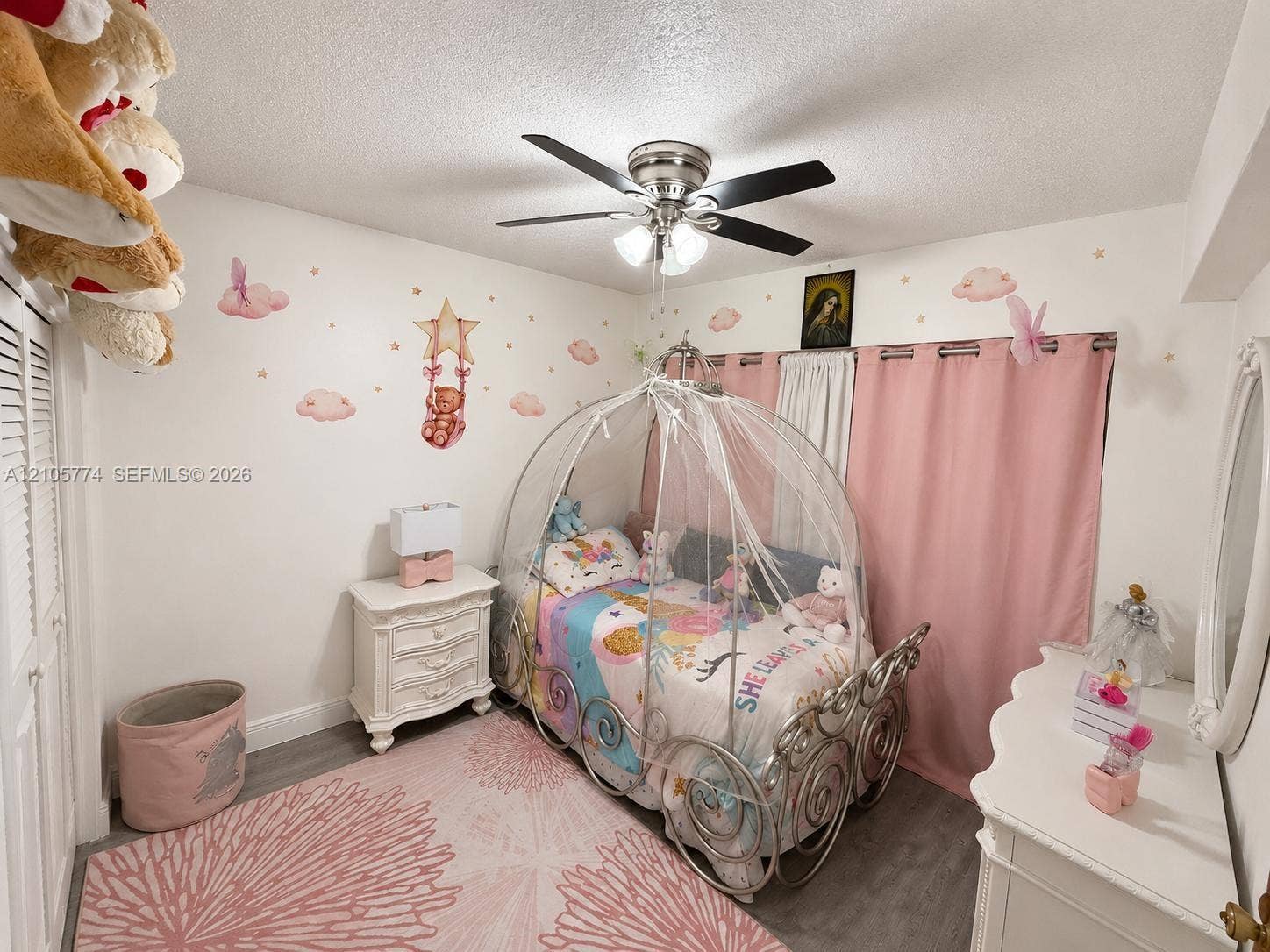 10343 Greenhouse Road, Pembroke Pines, FL 33026 Bedroom interior featuring wood-finish flooring, a multi-blade ceiling fan with integrated lighting, and closet space with louvered doors