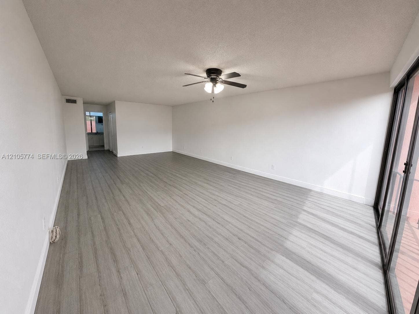 10343 Greenhouse Road, Pembroke Pines, FL 33026 Wood-finish flooring, ceiling fan with integrated light fixture, and sliding glass doors