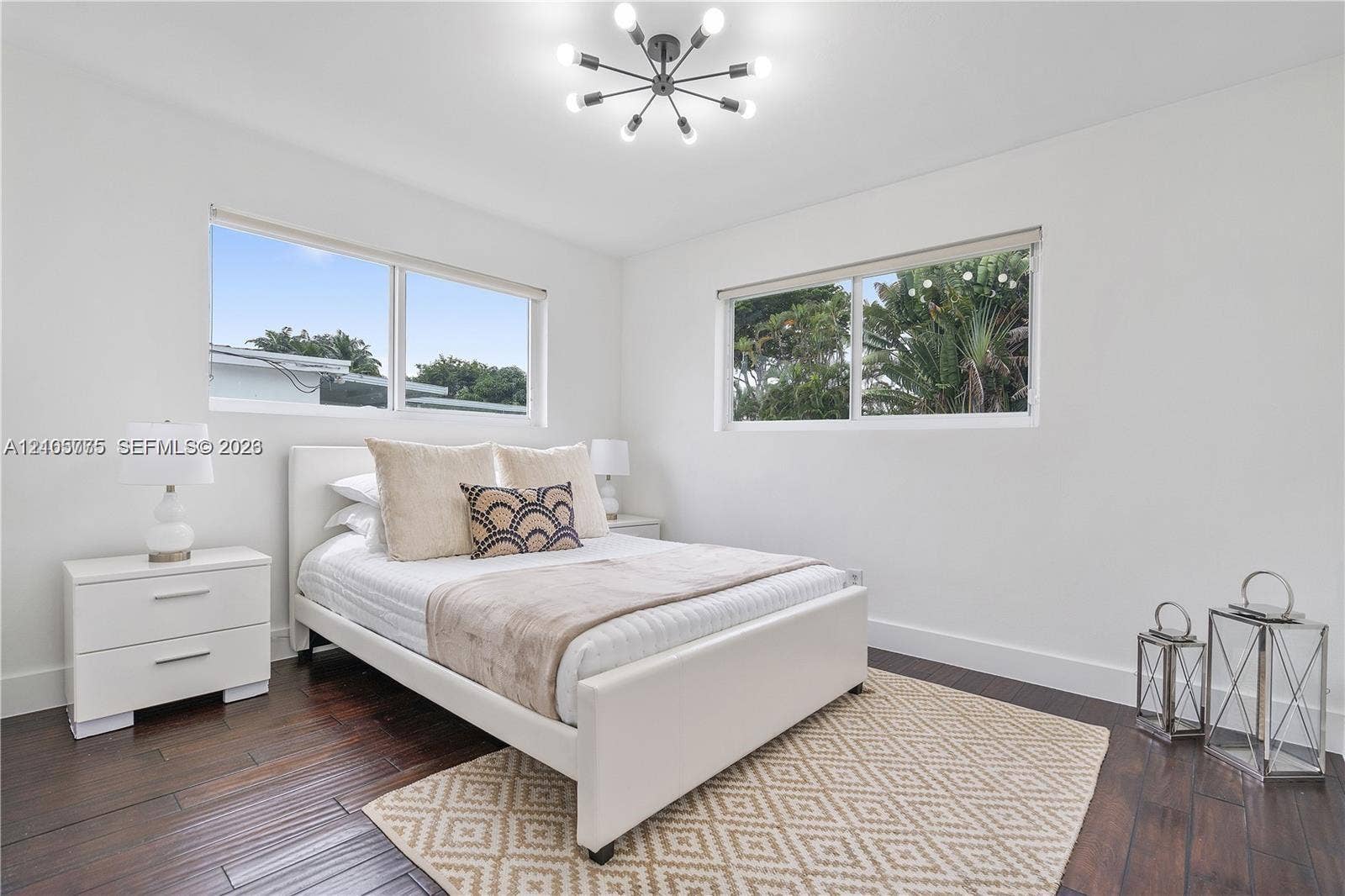 21230 NE 24th Court, Miami, FL 33180 Wood-finish flooring, multi-arm sputnik-style ceiling light fixture, and dual horizontal windows