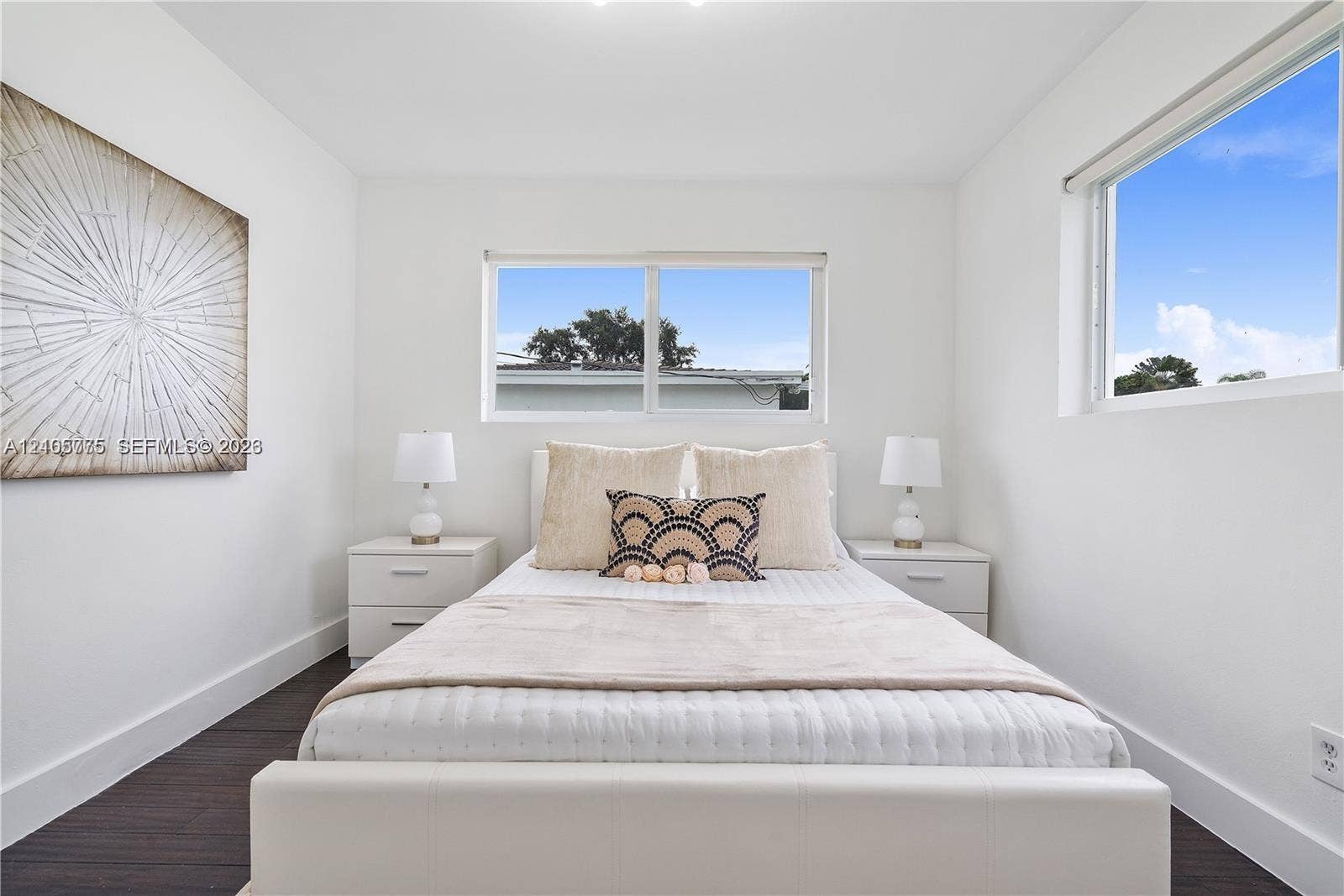 21230 NE 24th Court, Miami, FL 33180 Room featuring dark wood-finish flooring, white walls, and two large windows