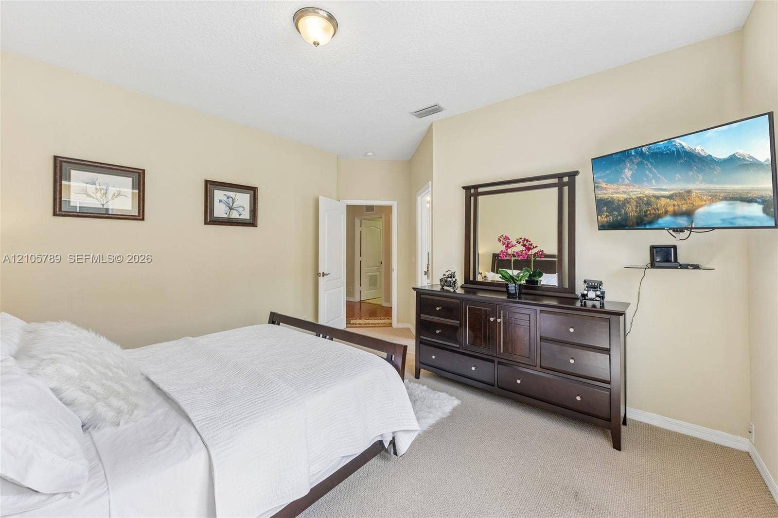 6353 SW 191st Avenue, Pembroke Pines, FL 33332 Neutral-toned interior space featuring vaulted ceilings, wall-to-wall carpeting, and a central ceiling-mounted light fixture