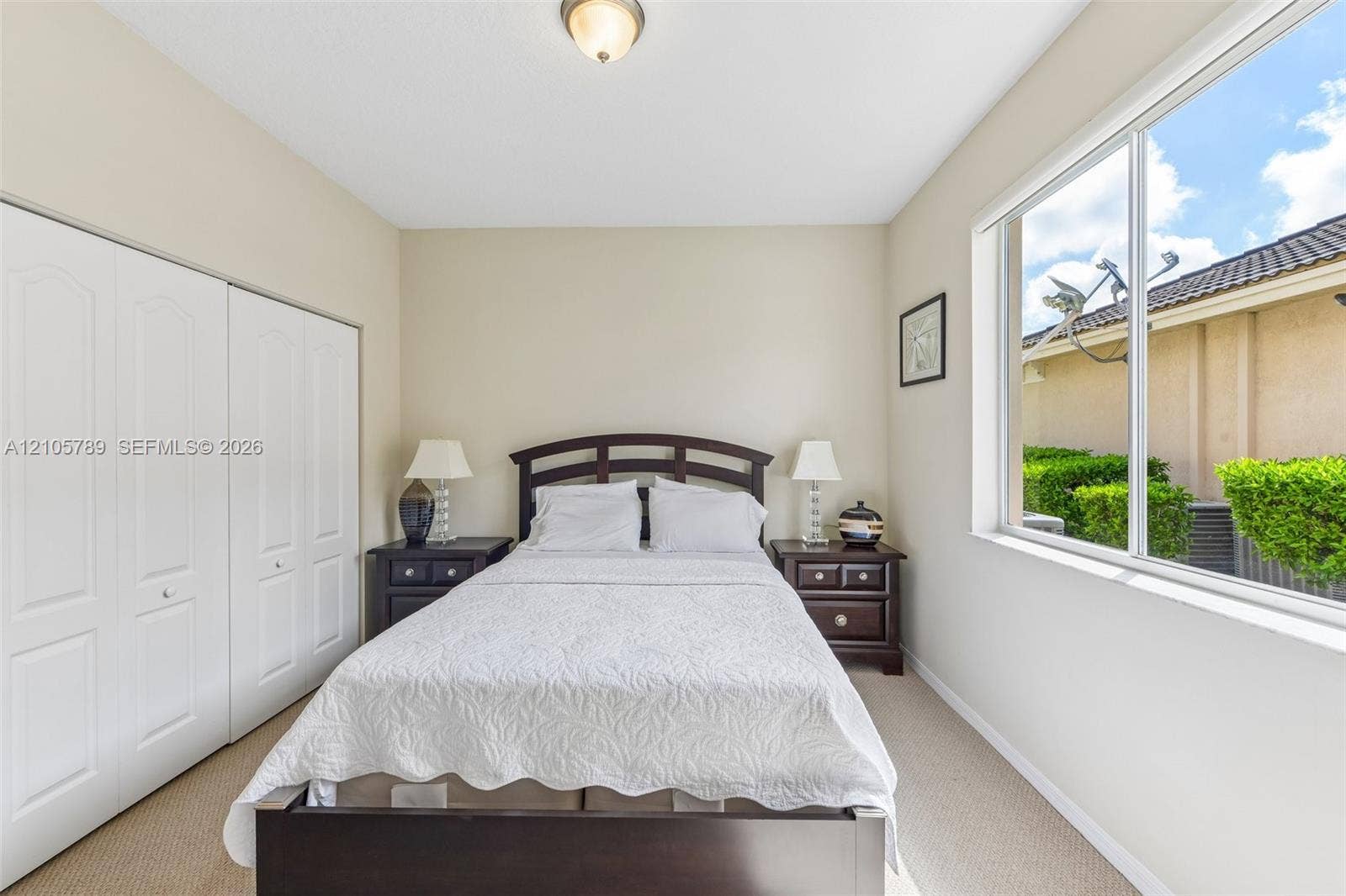 6353 SW 191st Avenue, Pembroke Pines, FL 33332 Neutral interior featuring a large sliding window, wall-to-wall carpeting, and floor-to-ceiling closets with double-paneled doors
