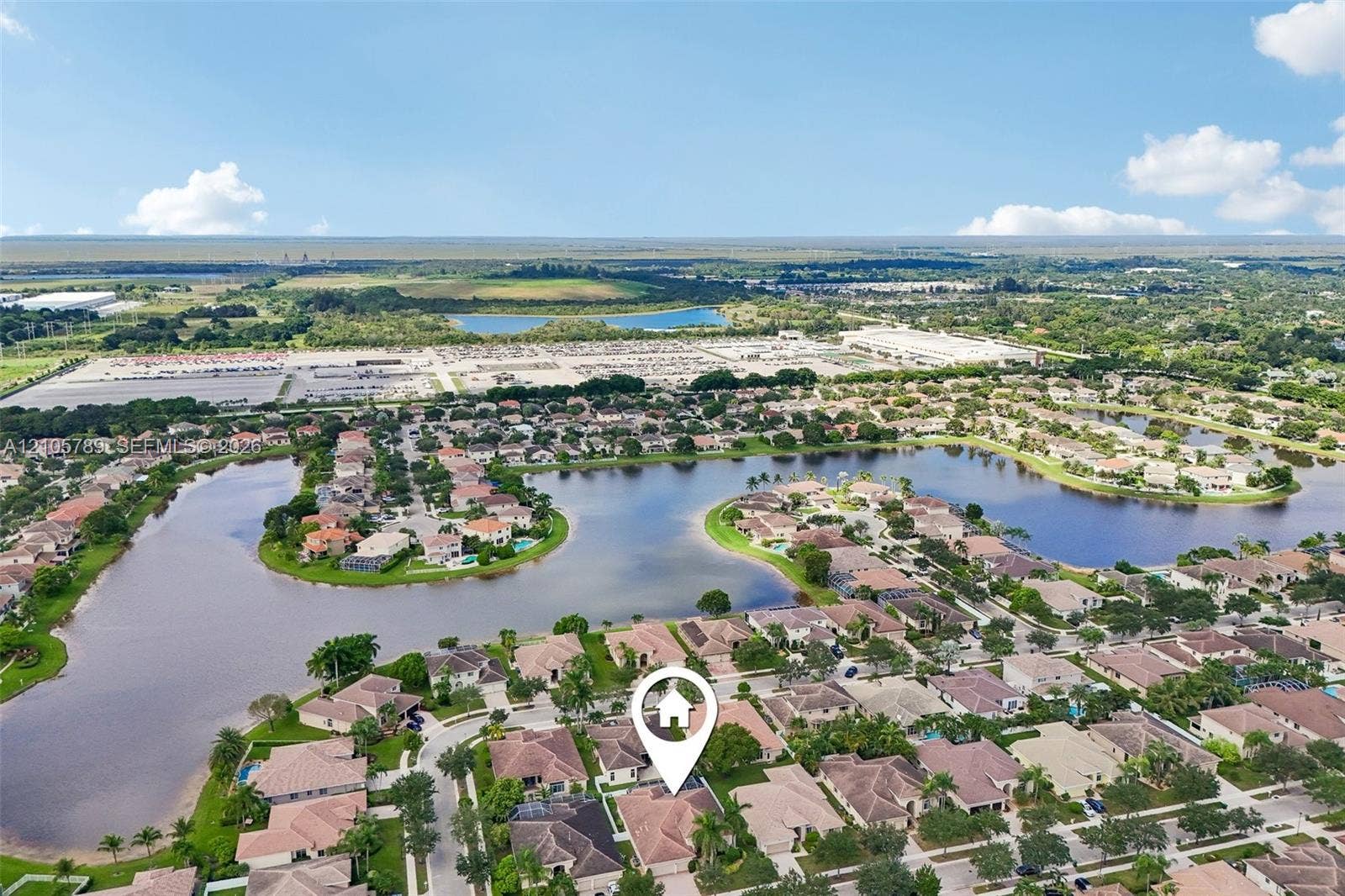 6353 SW 191st Avenue, Pembroke Pines, FL 33332 Aerial perspective featuring a multi-pitched roofline, residential lot, and surrounding water frontage