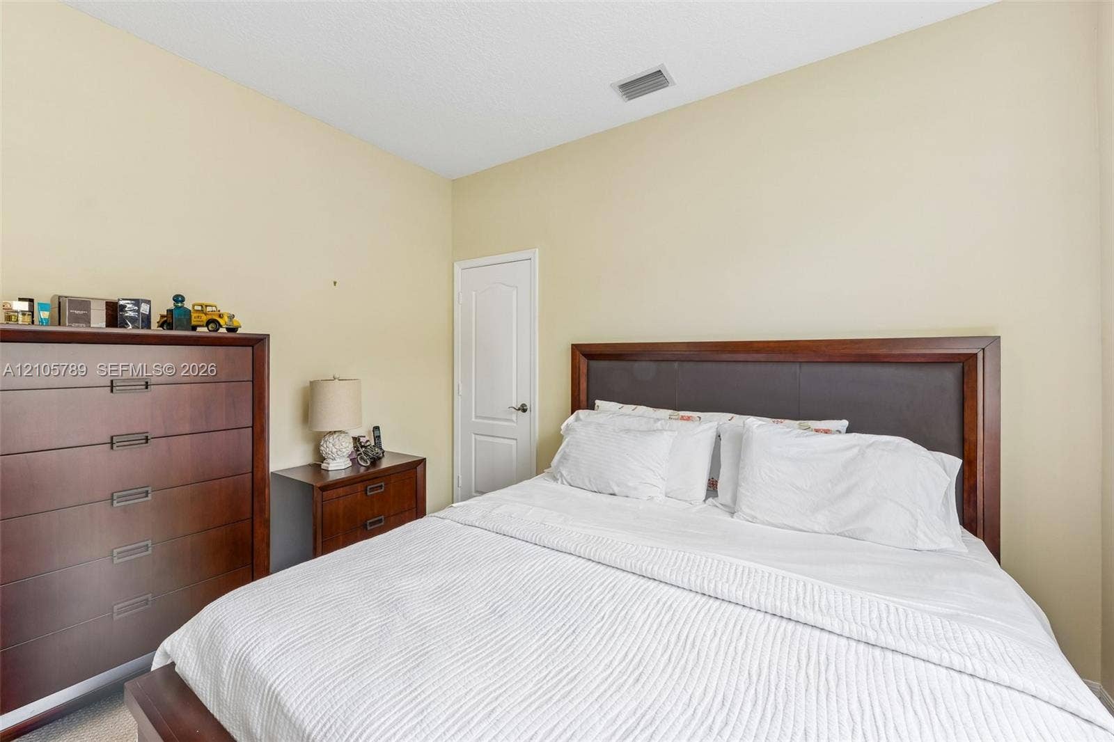 6353 SW 191st Avenue, Pembroke Pines, FL 33332 Neutral-toned interior featuring a solid-core interior door with a brushed nickel lever handle and recessed ceiling lighting