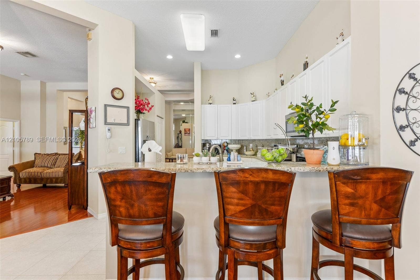 6353 SW 191st Avenue, Pembroke Pines, FL 33332 Kitchen featuring white cabinetry, stone-surface breakfast bar, recessed lighting, and stainless steel appliances