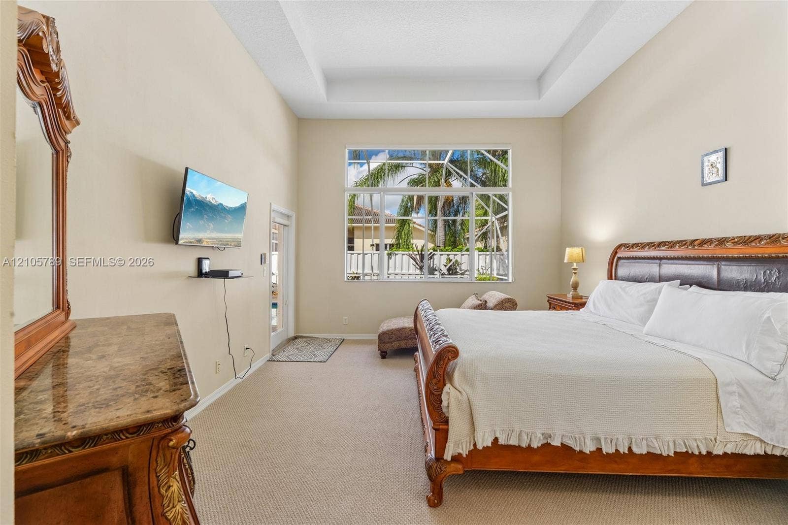 6353 SW 191st Avenue, Pembroke Pines, FL 33332 High ceilings with recessed tray detailing, expansive multi-pane window, and neutral carpeting