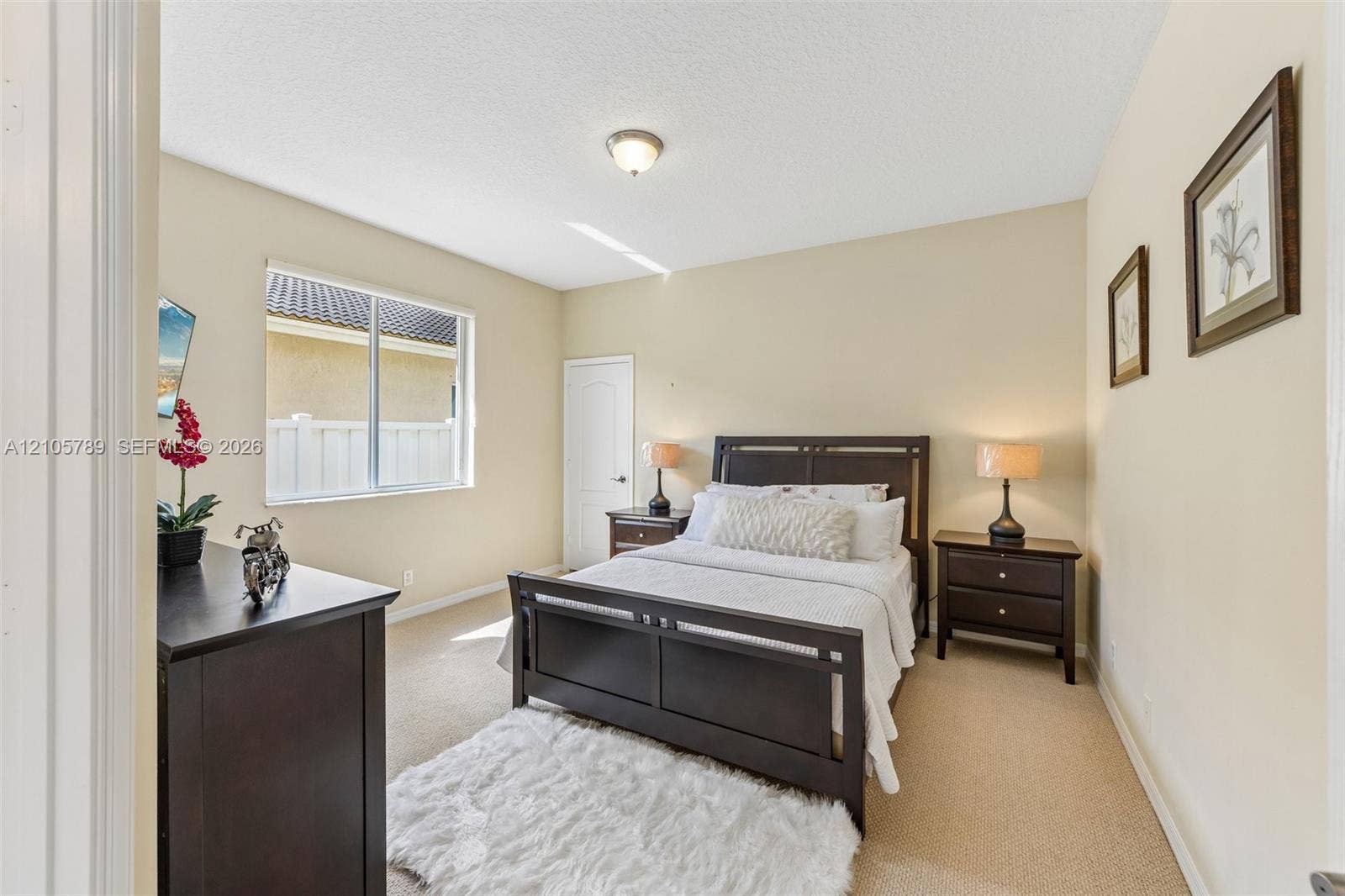 6353 SW 191st Avenue, Pembroke Pines, FL 33332 Neutral-toned room featuring wall-to-wall carpeting, a multi-pane sliding window, and a single-panel interior door