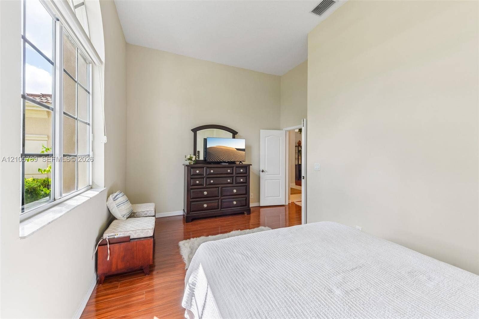 6353 SW 191st Avenue, Pembroke Pines, FL 33332 High ceilings featuring a large arched window with grid detailing and polished wood-finish flooring