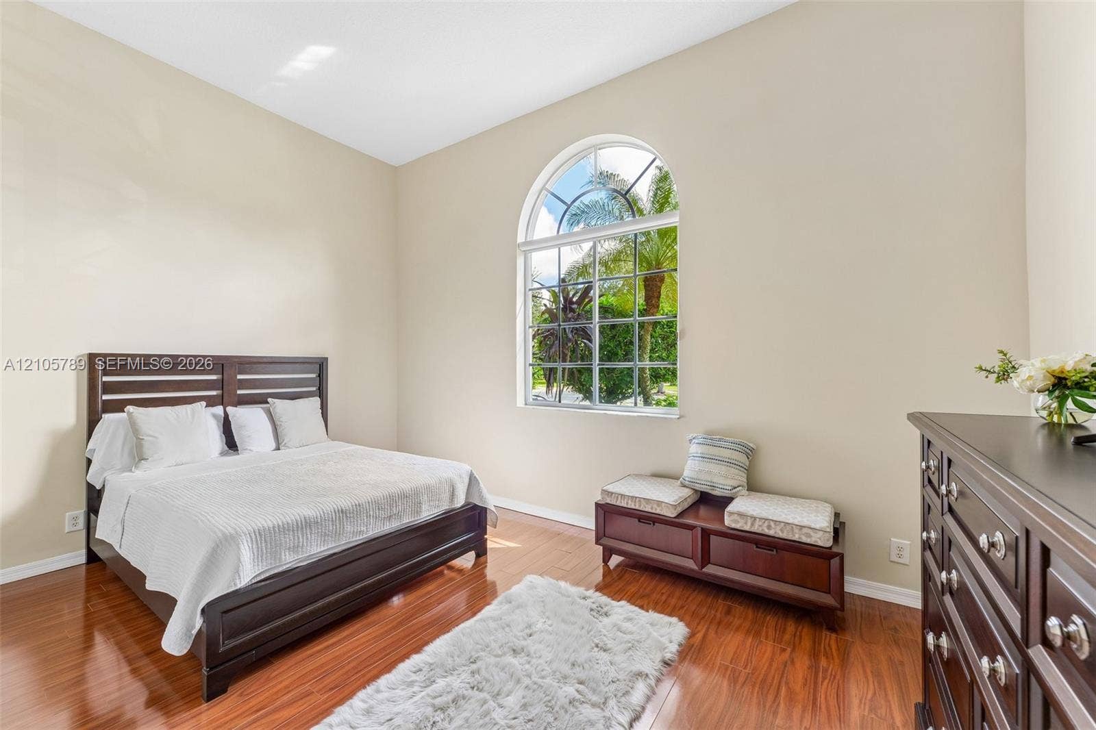 6353 SW 191st Avenue, Pembroke Pines, FL 33332 High ceilings, wood-finish flooring, and a large arched window with grid mullions