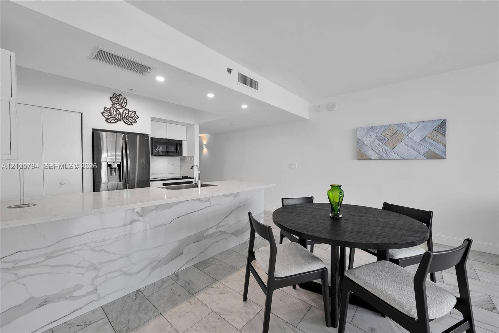 1830 S Ocean Drive, #4210, Hallandale Beach, Hallandale Beach, FL 33009 Kitchen featuring a waterfall-edge island with stone-finish countertop, stainless steel refrigerator, built-in microwave, and stone-finish tile flooring