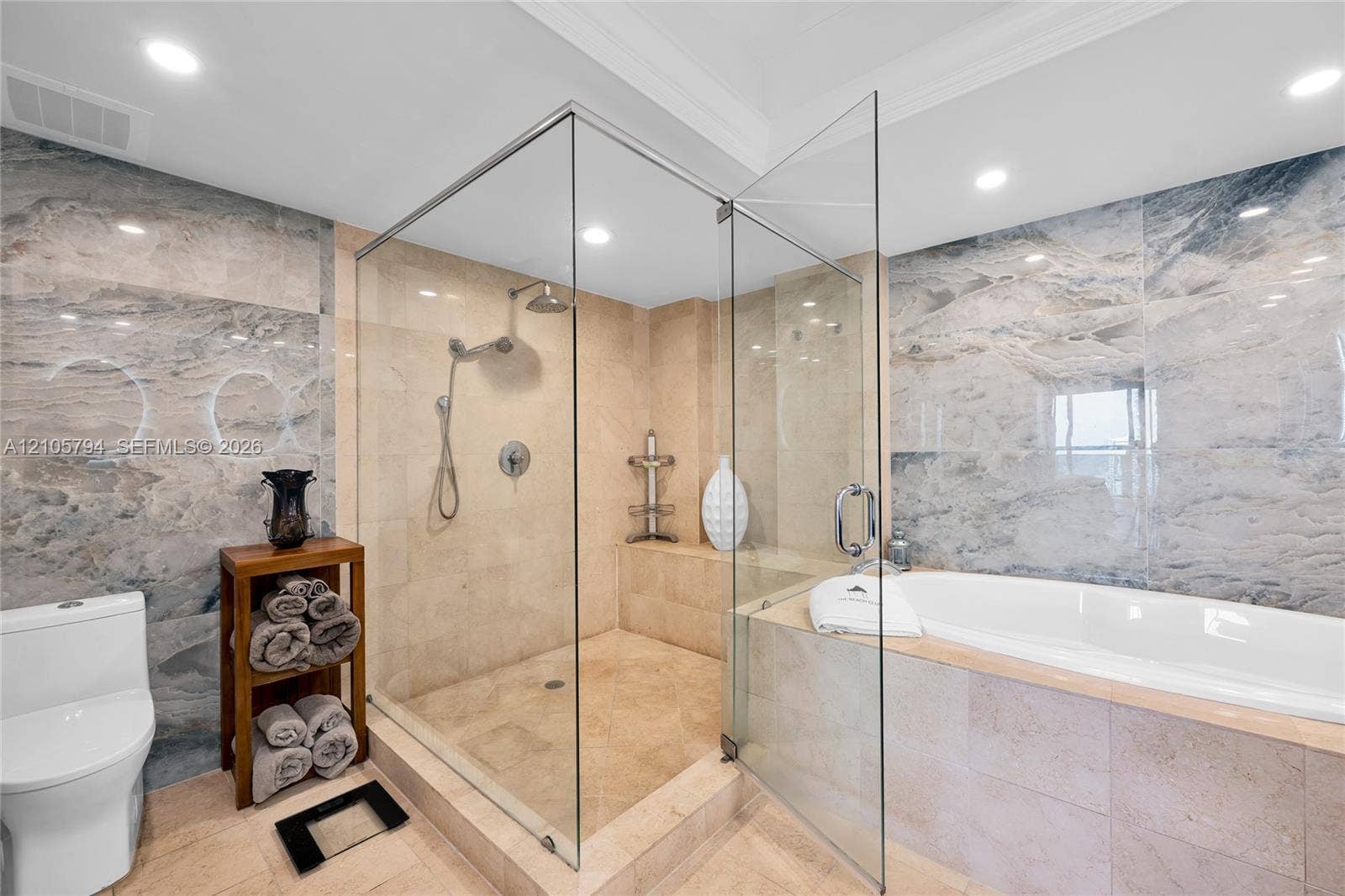 1830 S Ocean Drive, #4210, Hallandale Beach, Hallandale Beach, FL 33009 Walk-in frameless glass shower, built-in soaking tub with stone surround, large-format tile wall cladding, and recessed ceiling lighting