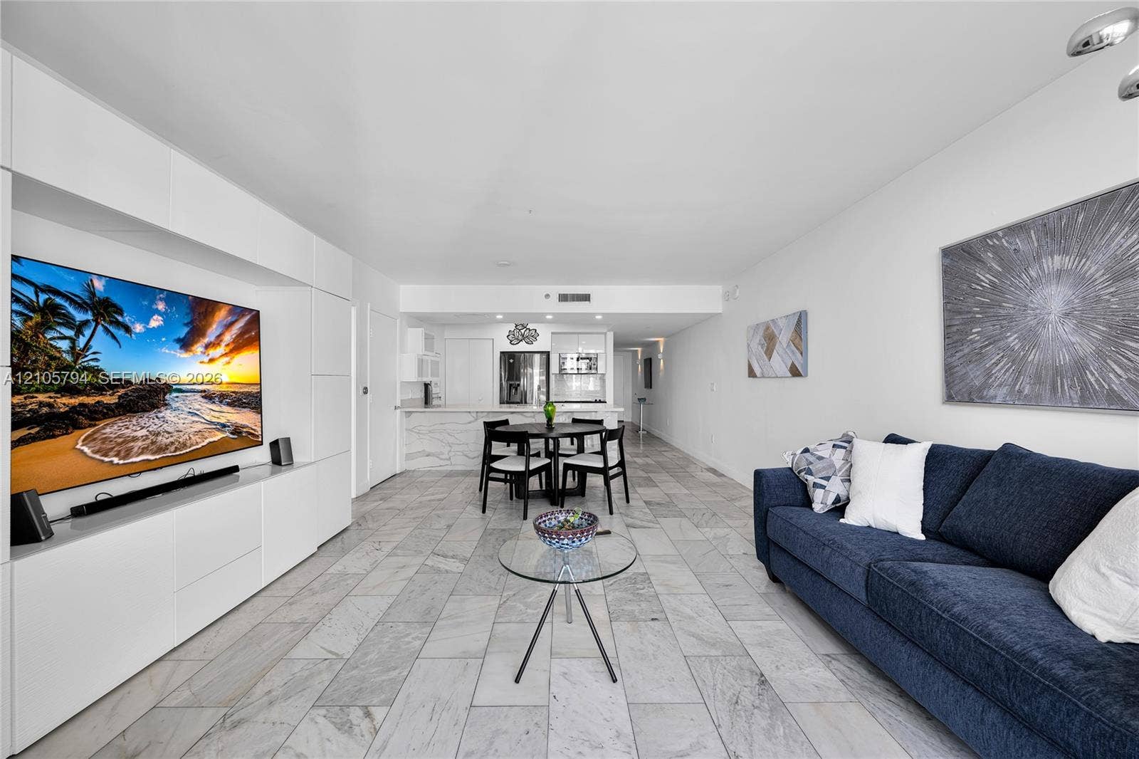 1830 S Ocean Drive, #4210, Hallandale Beach, Hallandale Beach, FL 33009 Open-concept living space featuring stone-style tile flooring, floor-to-ceiling built-in white cabinetry, recessed ceiling lighting, and a breakfast bar with stone-style countertops
