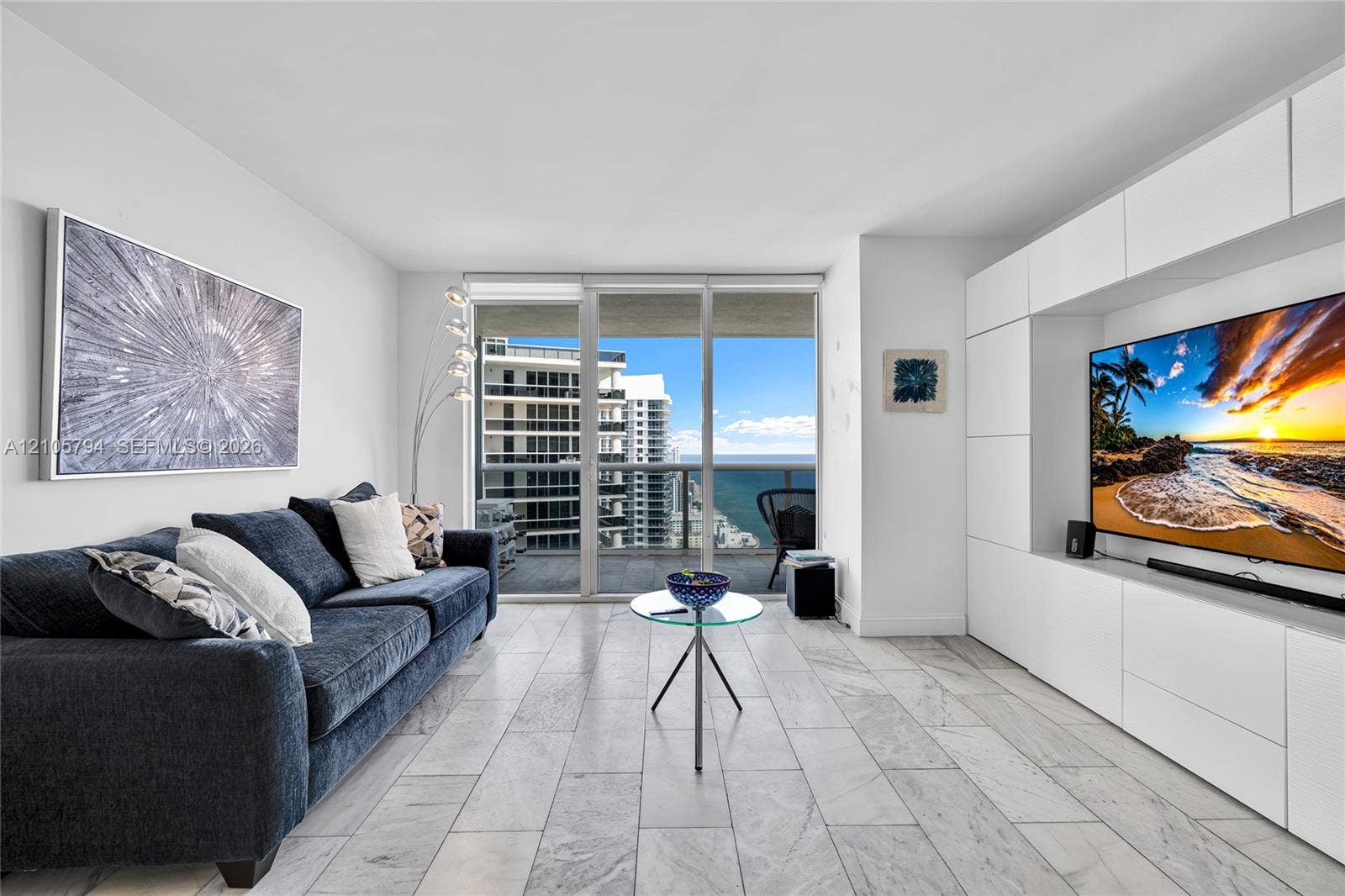 1830 S Ocean Drive, #4210, Hallandale Beach, Hallandale Beach, FL 33009 Floor-to-ceiling glass sliding doors, custom white built-in wall cabinetry, stone-finish tile flooring, and a private balcony