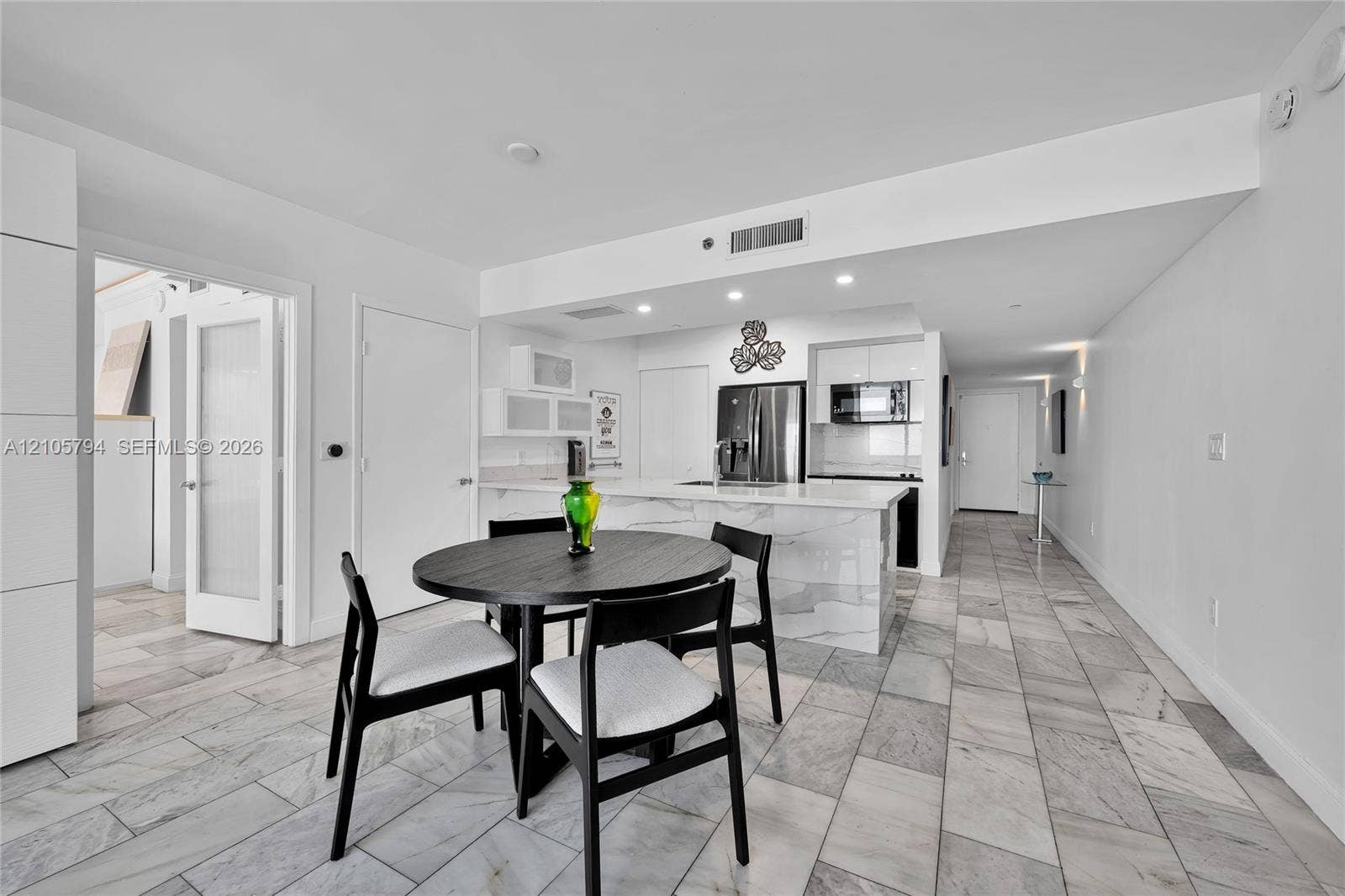 1830 S Ocean Drive, #4210, Hallandale Beach, Hallandale Beach, FL 33009 Kitchen featuring a waterfall-edge stone island, high-gloss cabinetry, stainless steel appliances, recessed lighting, and stone flooring
