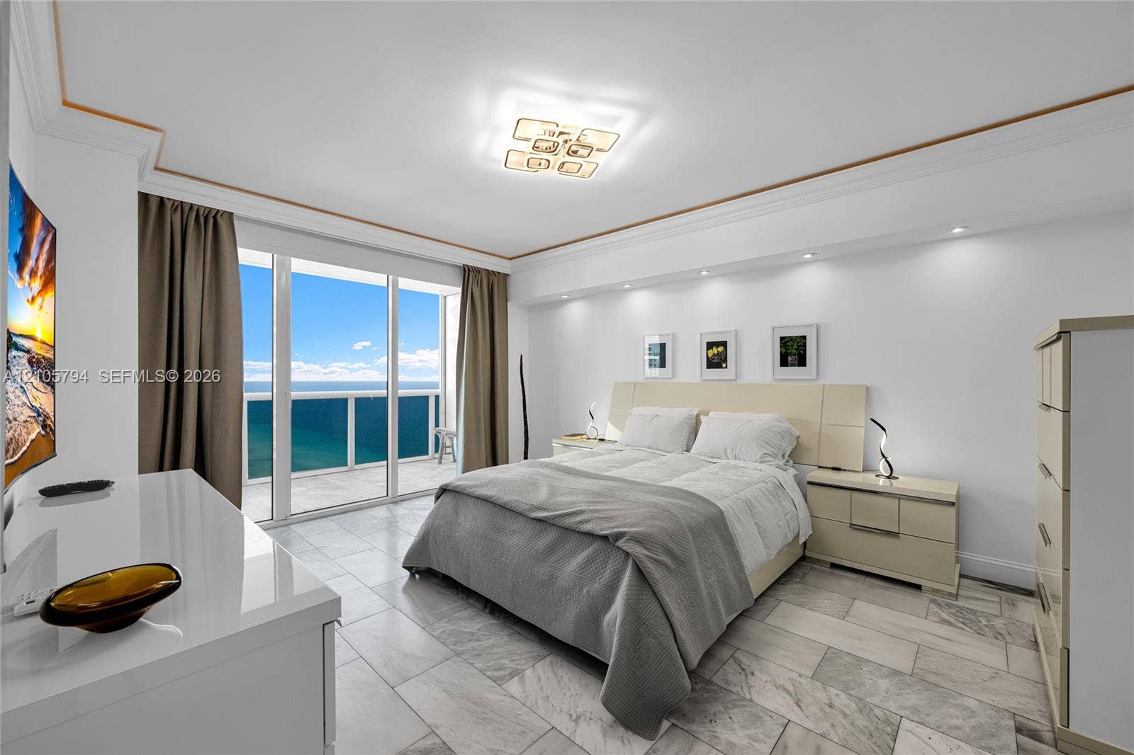 1830 S Ocean Drive, #4210, Hallandale Beach, Hallandale Beach, FL 33009 Stone flooring, recessed ceiling lighting, decorative crown molding, and floor-to-ceiling glass doors opening to a balcony with ocean exposure