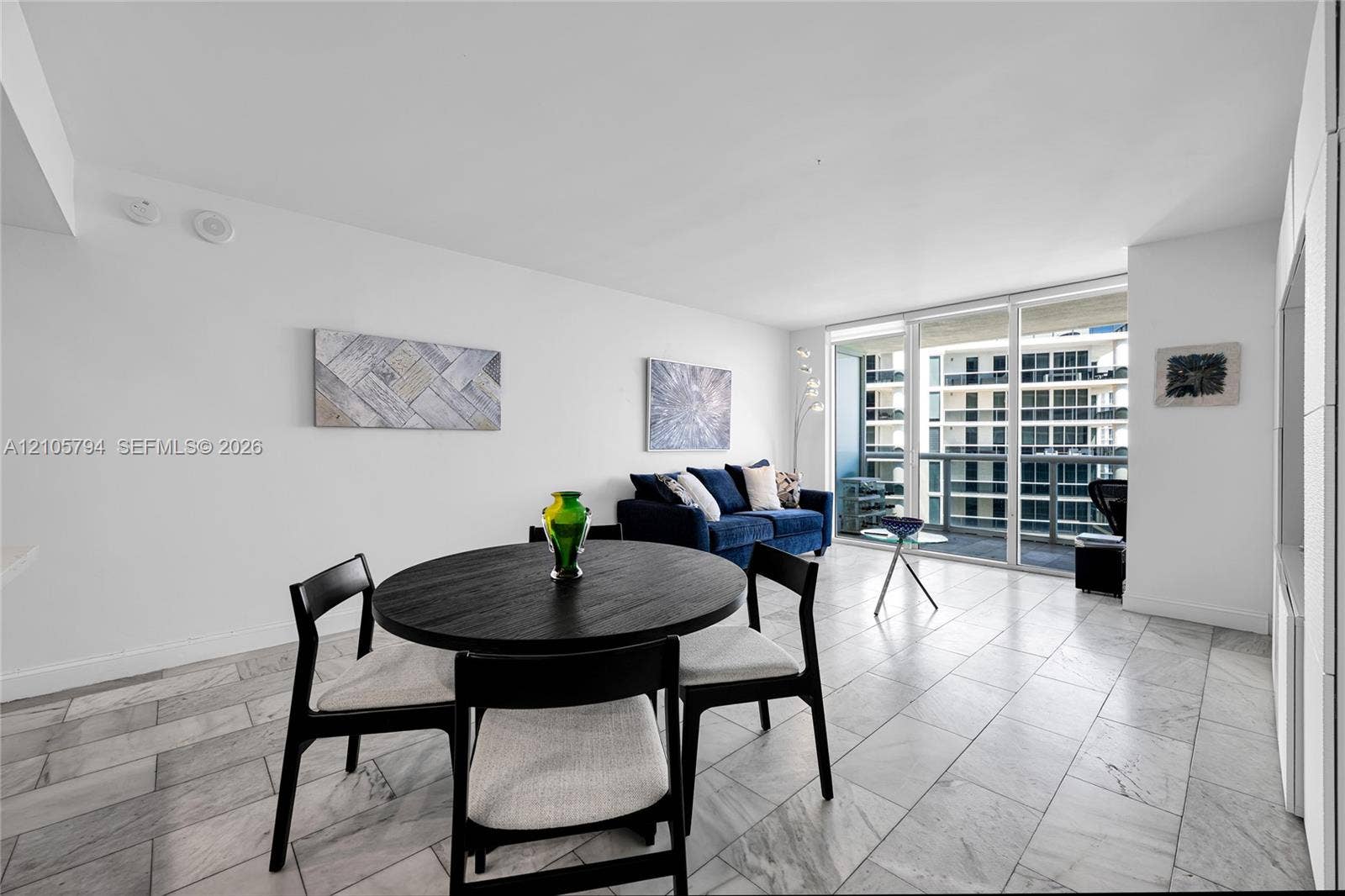 1830 S Ocean Drive, #4210, Hallandale Beach, Hallandale Beach, FL 33009 Open floor plan featuring large-format stone tile flooring and floor-to-ceiling glass sliding doors opening to a private balcony