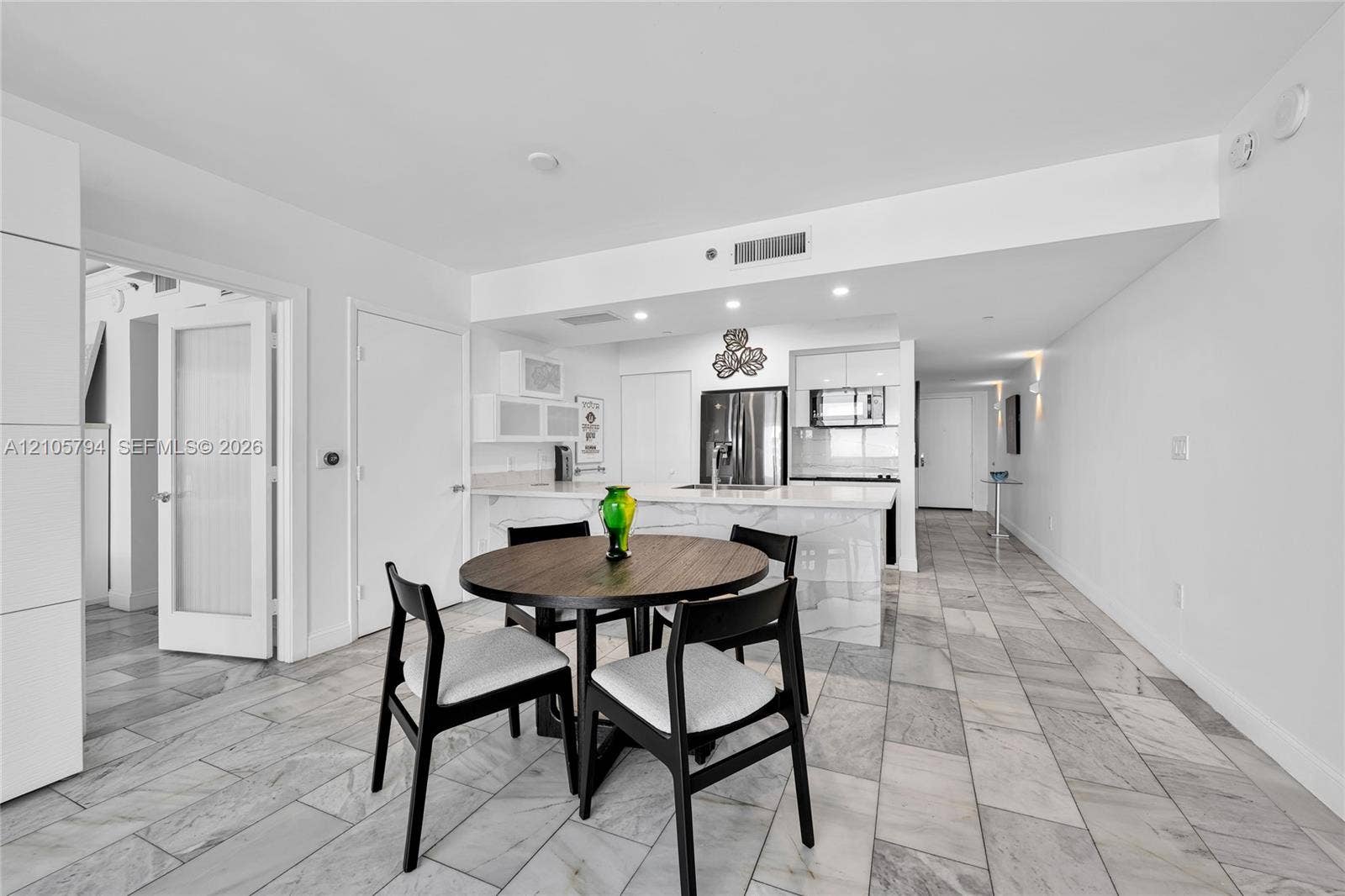 1830 S Ocean Drive, #4210, Hallandale Beach, Hallandale Beach, FL 33009 Kitchen featuring a waterfall-edge island, stone-patterned countertops, recessed lighting, and large-format tile flooring